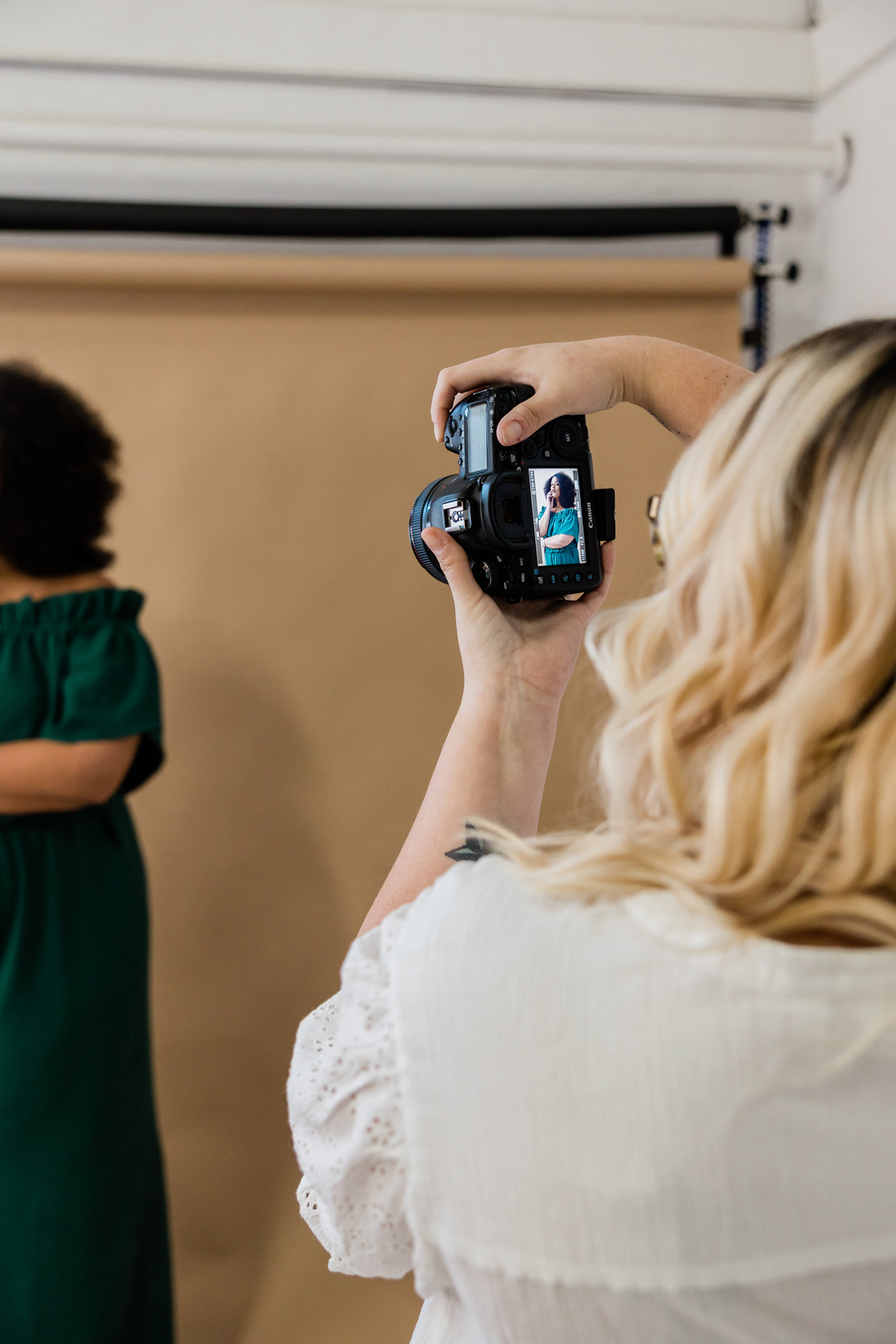 Female Photographer Taking Photos of Model in Studio